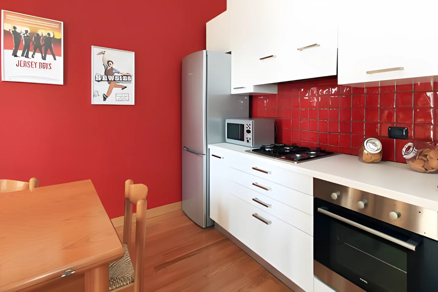 The open-plan living room and kitchen corner, bright with natural light